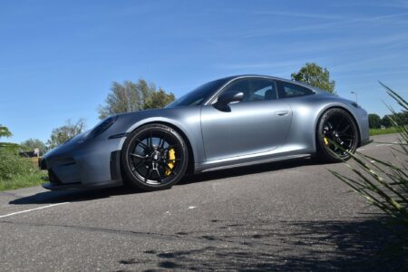 Porsche 911 GT3 Touring Finds Its Edge Without the Wing Porsche 911 GT3 Touring parked on a road in a subtle performance car setting