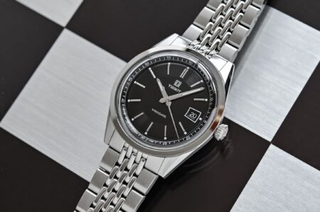 Where Value Meets Virtue in Six Affordable Mechanical Watches Six affordable mechanical watches arranged on a clean editorial tabletop