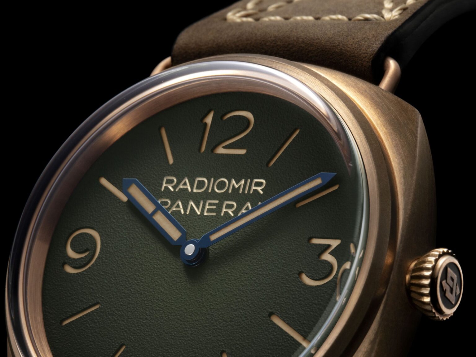 Panerai Radiomir Bronzo PAM00760 with green dégradé dial and bronze case beside a classic wooden yacht