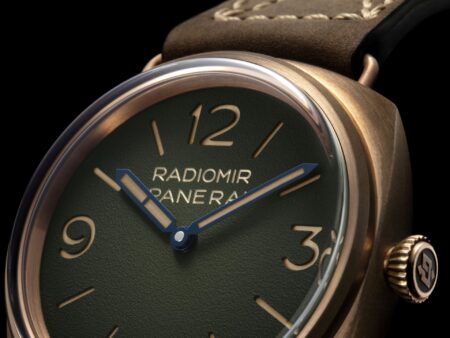 Panerai Radiomir Bronzo PAM00760 with green dégradé dial and bronze case beside a classic wooden yacht