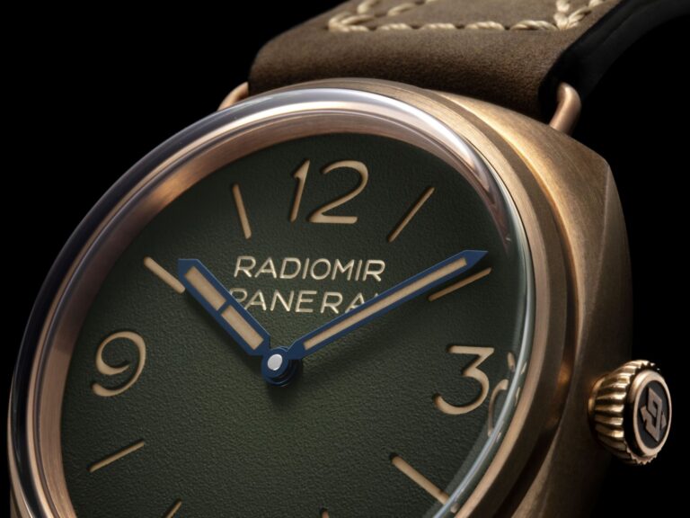 Panerai Radiomir Bronzo PAM00760 with green dégradé dial and bronze case beside a classic wooden yacht