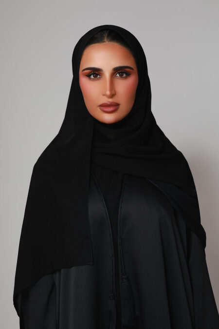 Buthaina Mohamed Al Emadi wearing an elegant modern abaya with refined embroidery