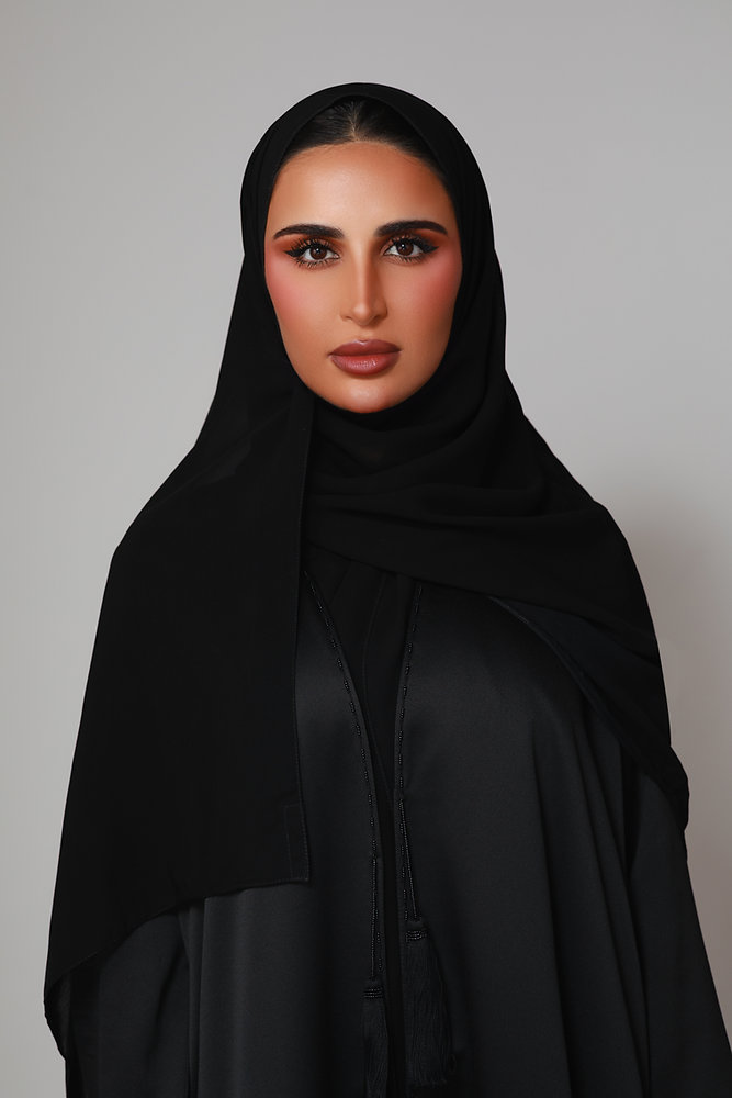 Buthaina Mohamed Al Emadi wearing an elegant modern abaya with refined embroidery