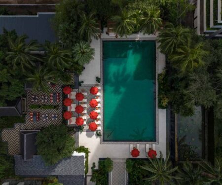 Riverfront Anantara resort terrace in Southeast Asia with tropical greenery and calm water views