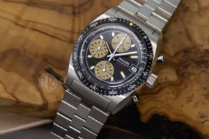 Nivada Grenchen Autochron MecaQuartz with black dial, tan subdials and stainless steel bracelet