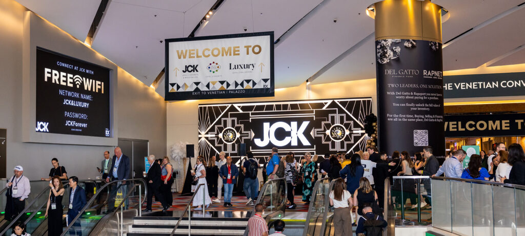 Attendees viewing watches at a luxury trade show booth in Las Vegas