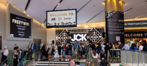 Attendees viewing watches at a luxury trade show booth in Las Vegas