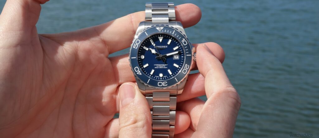 Longines HydroConquest 42mm blue dial dive watch on bracelet near the water