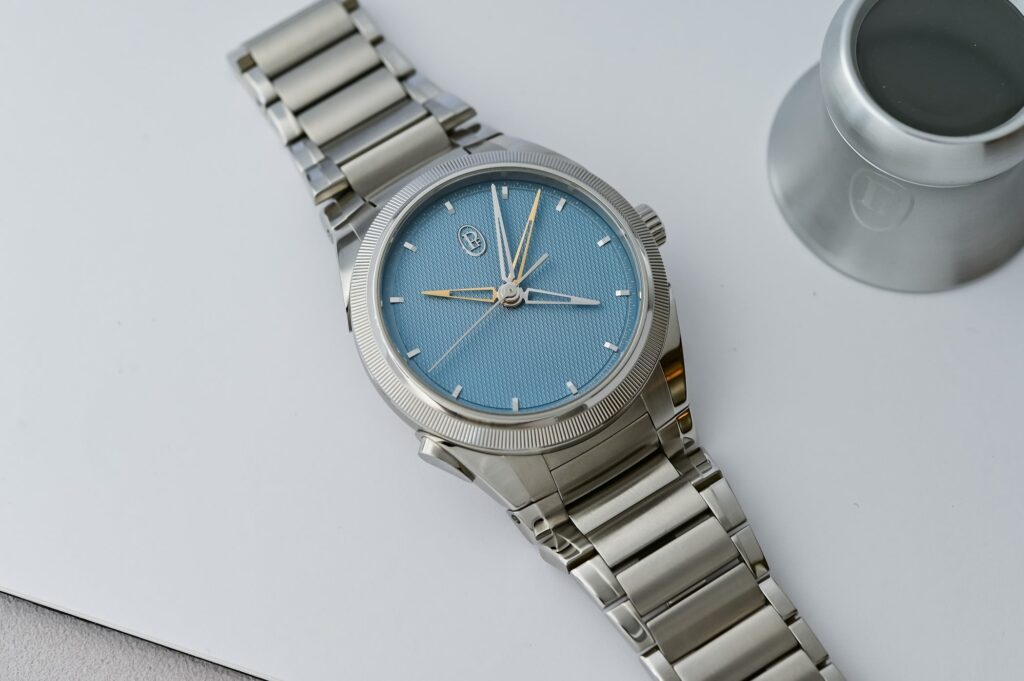 A group of modern luxury chronograph watches arranged on a dark studio surface
