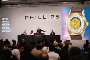 Collectors attending a Geneva watch auction viewing in a luxury hotel setting