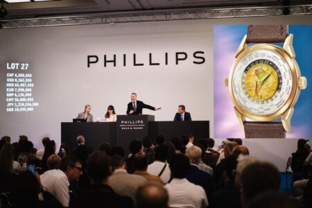 Collectors attending a Geneva watch auction viewing in a luxury hotel setting