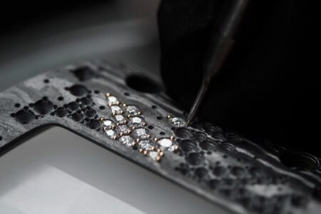 Macro view of a gem-set Richard Mille tonneau case showing diamonds integrated into a technical case structure