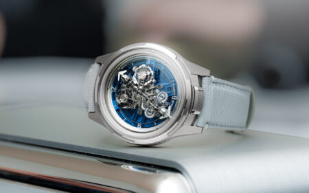 A modern watch editor’s desk with Geneva watch fair notes, vintage-inspired watches and exhibition passes