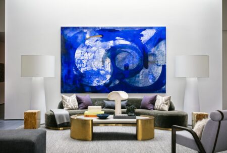Modern living room with large abstract artwork above a neutral sofa
