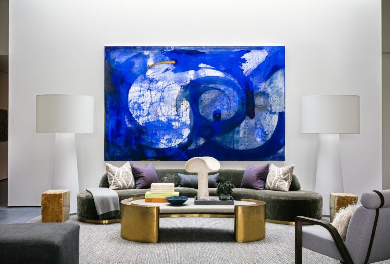 Modern living room with large abstract artwork above a neutral sofa