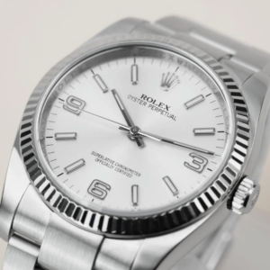 Close-up of a classic watch dial showing applied logo, seconds hand, signed crown and compact lugs