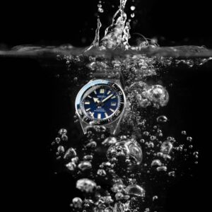 Dive watch underwater with bubbles around the case and bracelet