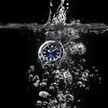 Dive watch underwater with bubbles around the case and bracelet
