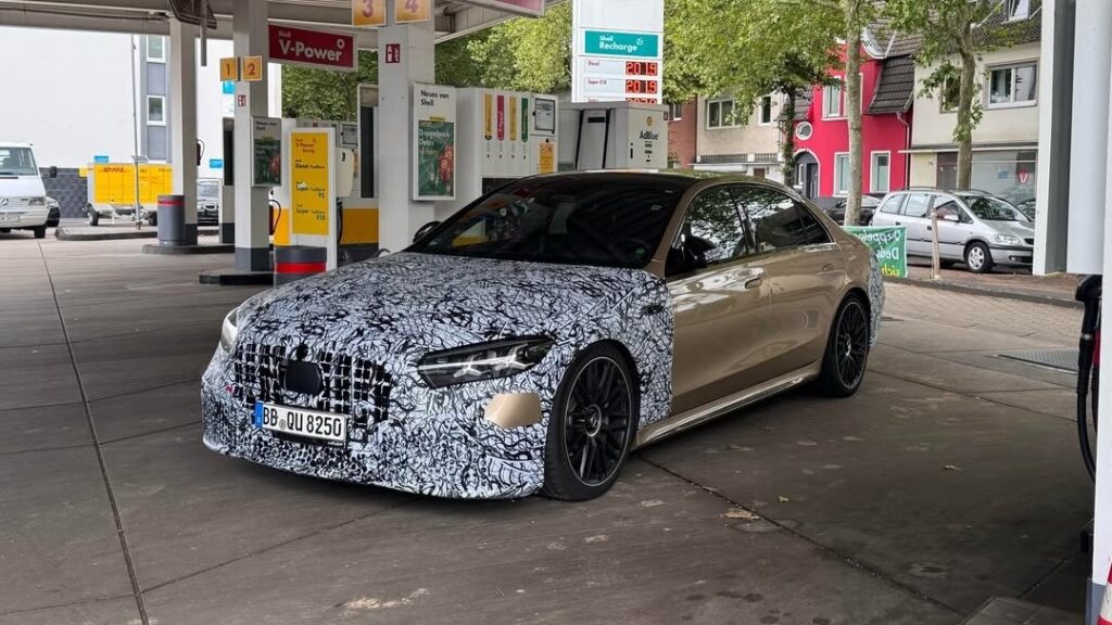 2027 Mercedes-AMG S63 prototype in a golden exterior finish with camouflage