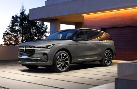 Lincoln Nautilus Hybrid Makes Luxury Feel More Practical Lincoln Nautilus Hybrid luxury SUV driving on a modern city road