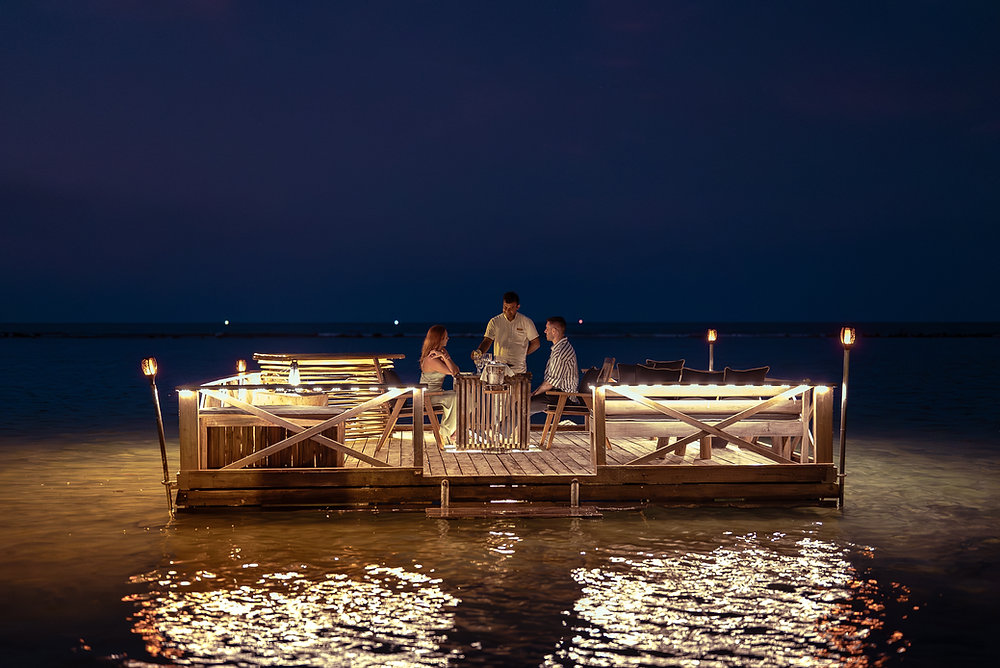 Aqua Lounge floating dining platform on the waters of Pasikudah Bay at sunset