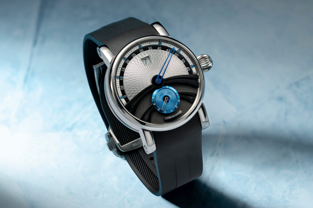Chronoswiss Delphis Glacier Freezes the Brand’s Jumping-Hour Display in Titanium Chronoswiss Delphis Glacier titanium watch with silver and blue guilloché dial