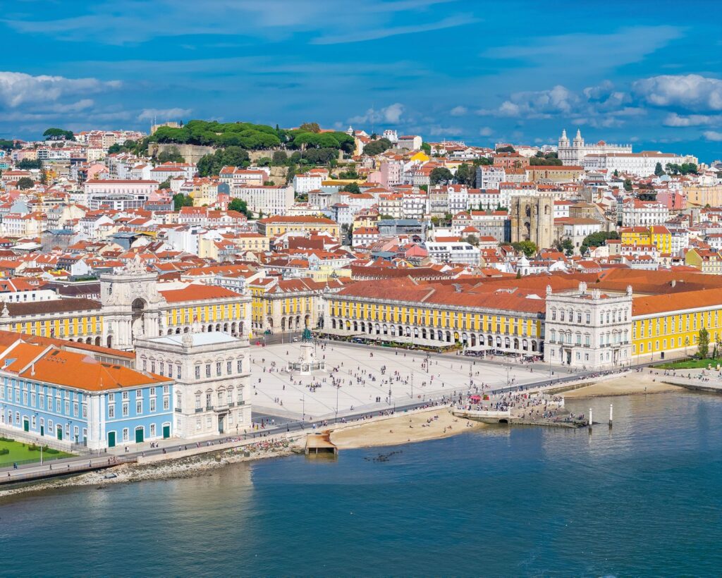 Lisbon Still Has Europe’s Most Seductive Slow Burn Lisbon rooftops and the Tagus River at sunset