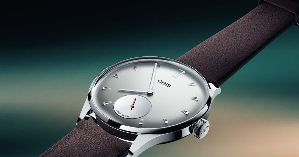 Oris Gives the Artelier a Reflective Twist for Hölstein Edition 2026 Oris Hölstein Edition 2026 Artelier watch with light grey dial and red small seconds hand