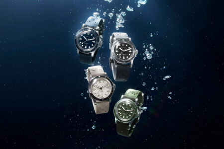 Selection of colourful skin diver watches arranged beside a swimming pool for summer wear