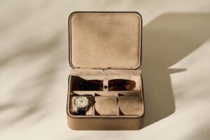 Five Watch Accessories Worth Your Attention in June 2026 Luxury watch winders and leather travel cases arranged on a modern dresser