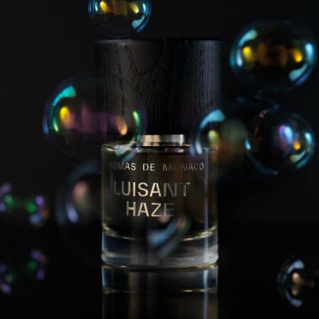 Thomas de Monaco Luisant Haze Makes Sweetness Feel Weightless Thomas de Monaco Luisant Haze perfume bottle in soft diffused light