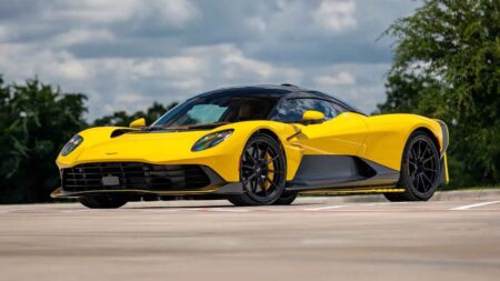 Two Nearly New Aston Martin Valhallas Are Heading to Monterey Car Week Ultra Yellow and Speedway White Aston Martin Valhalla hypercars displayed together