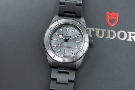 Five Modern Dive Watches That Deserve a Place on Your Shortlist Five modern dive watches arranged on a dark wet surface with ceramic, titanium and steel cases