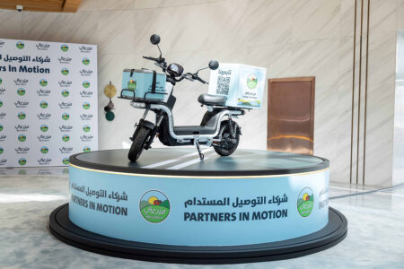 Mazzraty Backs Qatari Retailers With Electric Delivery Bikes Electric delivery bike outside a grocery store in Qatar representing Mazzraty Partners in Motion