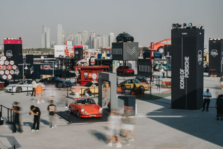 Porsche sports cars gathered at an outdoor festival in Dubai