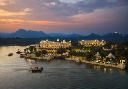 The Leela’s Global Rise Puts Indian Luxury Hospitality in the Spotlight The Leela-style Indian palace hotel exterior at golden hour with landscaped gardens and luxury hospitality atmosphere