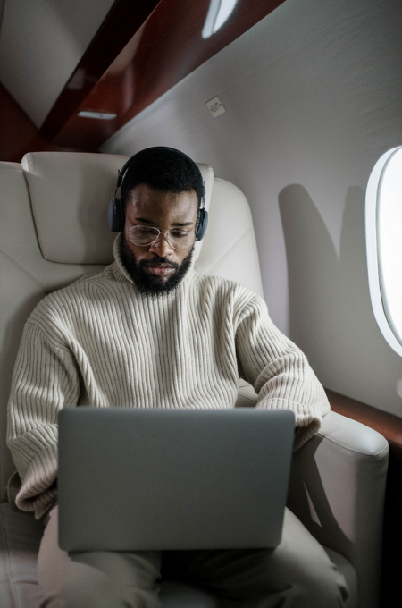 Private jet cabin passenger using high-speed satellite internet during flight