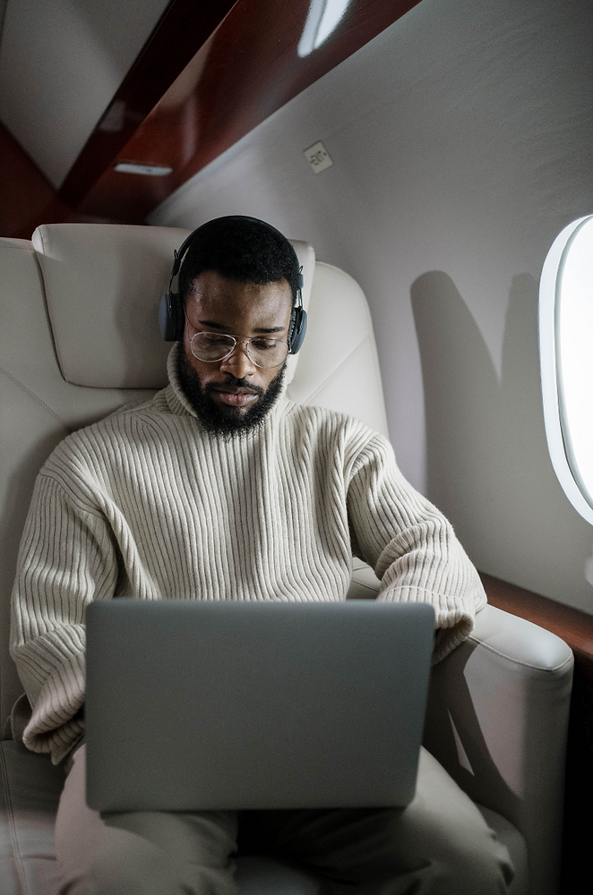 Private jet cabin passenger using high-speed satellite internet during flight