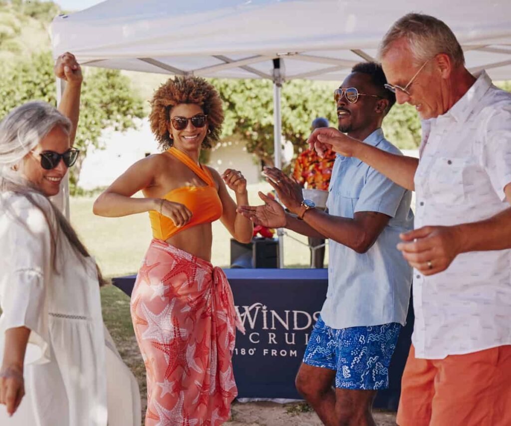 Windstar Cruises makes the case for luxury at a smaller scale Windstar Cruises yacht sailing near a sunlit coastal harbour