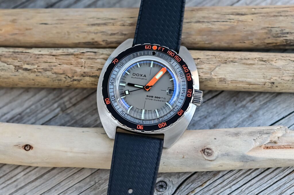 Doxa Puts the SUB 300 Clive Cussler Edition in Grade 5 Titanium Doxa SUB 300 Ti5 Clive Cussler titanium dive watch with orange minute hand and black rubber strap