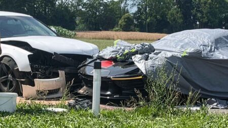 Ferrari Daytona SP3 Damaged in Storm-Hit Cavalcade Crash Ferrari Daytona SP3 with exposed carbon fibre parked roadside under a protective cover after a wet-weather crash