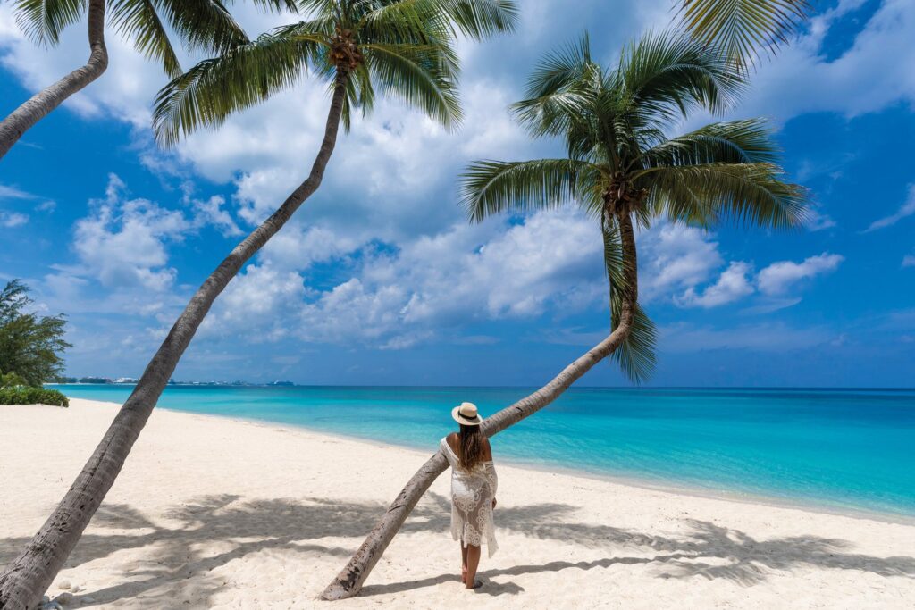 Cayman Islands Luxury Moves at an Island Pace Clear turquoise water and white sand on Seven Mile Beach in the Cayman Islands