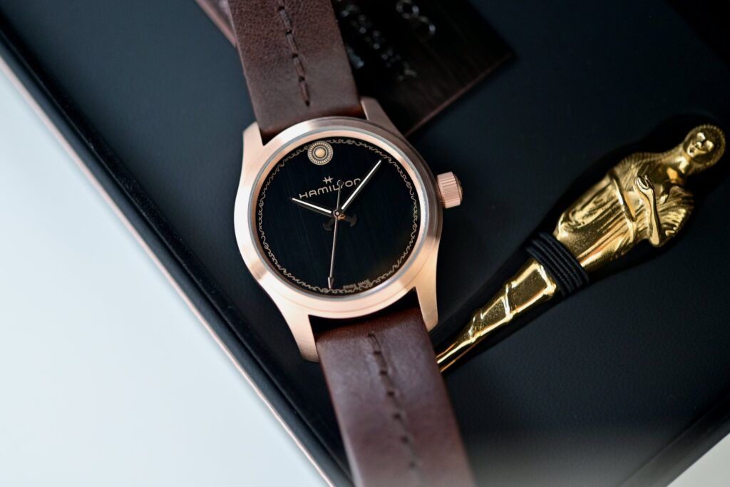 Hamilton Khaki Field Auto The Odyssey Limited Edition bronze watch with black textured dial and brown leather strap