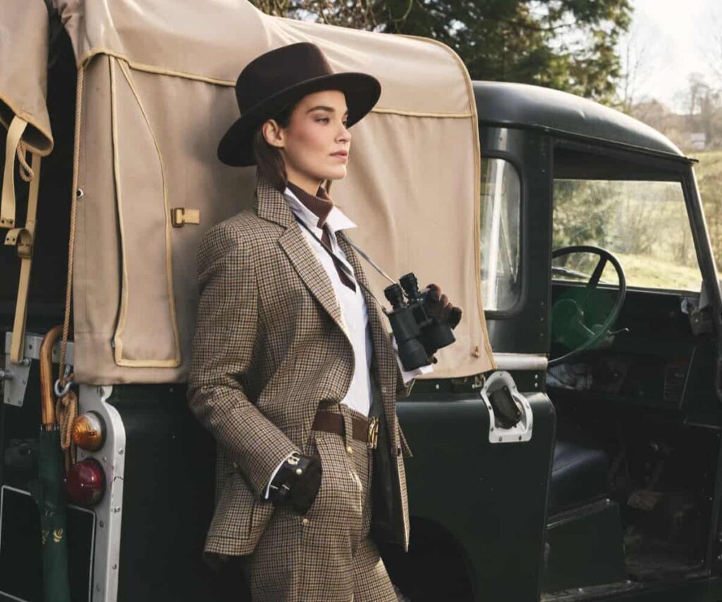 The Polished Country Guide to Britain’s Smartest Rural Escapes Elegant countryside wardrobe with riding boots and knitwear outside a luxury British country hotel