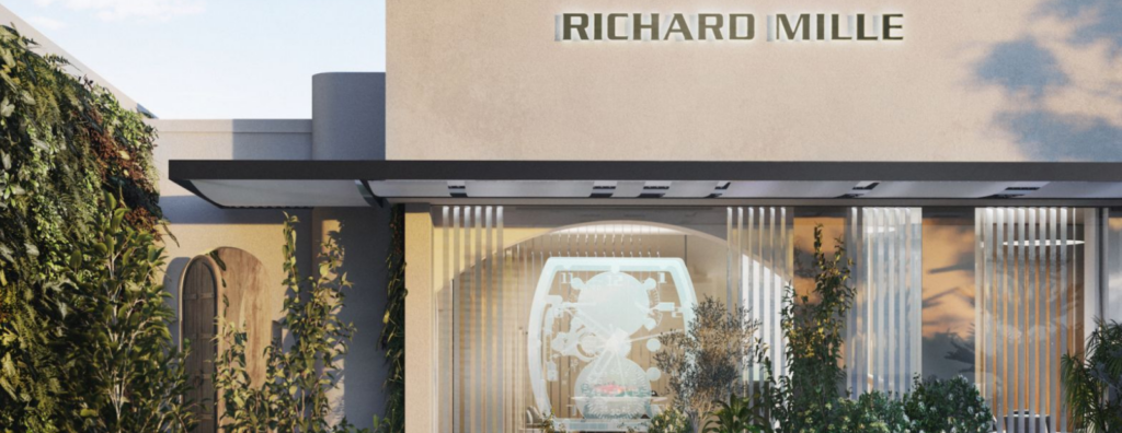 Private luxury watch salon with lounge seating, bar service and watches displayed for collectors