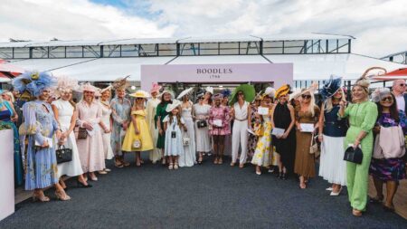 Guests in elegant summer outfits and statement hats at Salon Privé Ladies’ Day by Boodles at Blenheim Palace with supercars on the lawn
