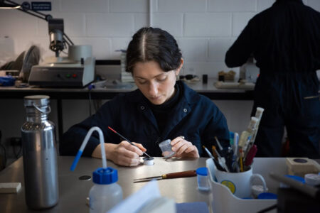 British Watchmaking Has Momentum but Not Enough Hands A British watchmaker working at a bench with precision tools and watch components
