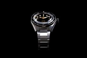 Worn & Wound Buys Lorier in a Landmark Microbrand Watch Deal Lorier watch on a desk beside watch tools and editorial notes