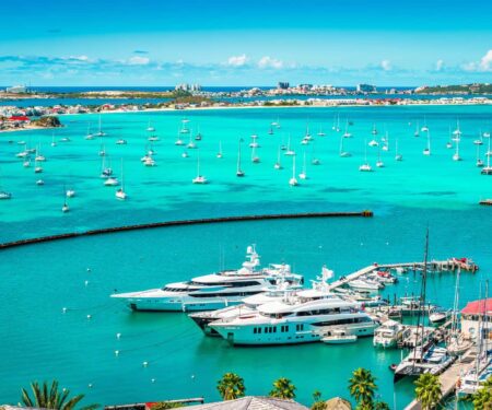 Why St Barts Is the Caribbean Superyacht Charter That Feels Different Superyachts anchored off St Barts near clear Caribbean water and a hilly coastline
