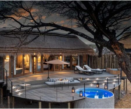 African Safari Lodges Are Raising the Bar on Luxury in the Wild Luxury safari vehicle at sunset on an African savannah with wildlife in the distance